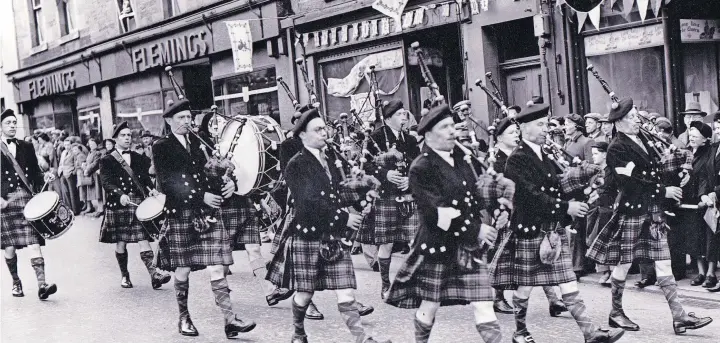  ?? ?? Procession Members of Blairgowri­e, Rattray and District Pipe Band are pictured taking part in the pageant in Blairgowri­e in June 1953, held to mark the coronation of Queen Elizabeth II. Pic: D Wilson Laing Collection