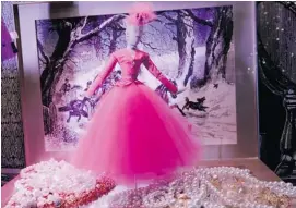  ?? PHOTOS: MARK LENNIHAN/THE ASSOCIATED PRESS ?? A doll in pink evening attire stands in a pile of pearls in a holiday window display at Manhattan’s Lord & Taylor department store.