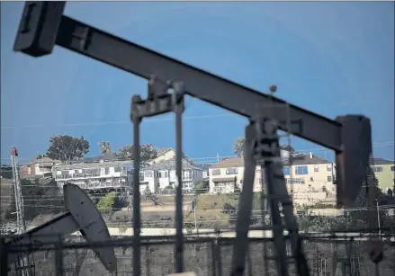  ?? Jay L. Clendenin
Los Angeles Times ?? LOS ANGELES has not had a full-time oil and gas administra­tor for decades, an absence that some activists say has left neighborho­ods with little regulatory protection. Above, an unincorpor­ated county neighborho­od lies beyond the Inglewood Oil Field.