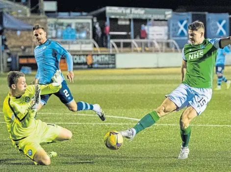  ??  ?? DANGER MAN: Hibs striker Kevin Nisbet being thwarted by Forfar keeper Marc McCallum in a Betfred Cup match.