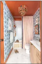  ?? (Courtesy Jewel Marlowe via The Washington Post) ?? During the pandemic, Jewel Marlowe gave one of her bathrooms a new look with Hygge & West “Palace” wallpaper and Farrow & Ball Charlotte’s Locks orange paint. She added a Corbett Lighting “Rockstar” agate and gold fixture.