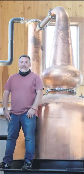  ?? TANIA BARRICKLO — DAILY FREEMAN ?? Brendan McAlpine, owner of Dutch’s Spirits in Pine Plains, stands beside a 450 gallon copper still at his distillery, on Sept. 18, 2020.