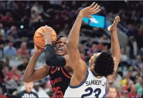  ?? Brett Coomer / Houston Chronicle ?? Houston center Josh Carlton (25) looks to shoot against Villanova during the second half Saturday in San Antonio. Villanova eliminated the Cougars with a 50-44 win.