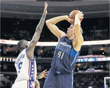  ?? AP ?? The Mavericks’ Dirk Nowitzki, right, goes up for a shot against the 76ers’ JaKarr Sampson in the first half.