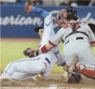  ?? AP PHOTO ?? TAG, YOU’RE OUT: Christian Vazquez nabs the Blue Jays’ Troy Tulowitzki trying to score during the Red Sox’ 8-7 victory last night in Toronto.