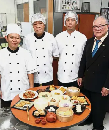  ??  ?? Good team: Chang (right) with some of his chefs who help him develop the company’s recipes.