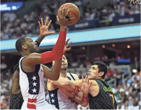  ?? BRAD MILLS, USA TODAY SPORTS ?? In the third quarter, John Wall, left, scored or assisted on 14 points in a row.