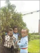  ??  ?? Child’s play: A young Fumbatha May (covering his eyes) with his cousin at home in Mdantsane