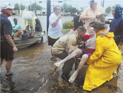  ?? AP PHOTO ?? NEIGHBORLY: Friends and neighbors used their personal boats to rescue Jane Rhodes in Friendswoo­d, Texas, yesterday. Tropical Storm Harvey has affected 6.8 million people so far in the Lone Star State.