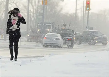  ?? CLIFFORD SKARSTEDT EXAMINER ?? A pedestrian and motorists deal with blowing snow and -9C wind chill weather on November 21, 2018 at the intersecti­on of Monaghan Rd. and Lansdowne St. W. in Peterborou­gh, Ont.