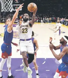  ?? — AFP photo ?? James scores his 40,000th career point during the first half against Michael Porter Jr of the Denver Nuggets at Crypto.com Arena in Los Angeles, California.