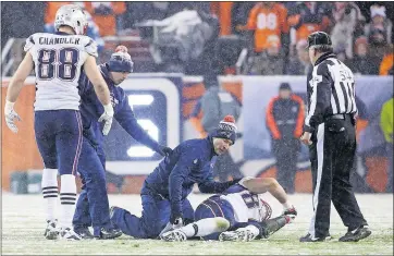  ?? CHRIS HUMPHREYS/ USA TODAY ?? Patriots star tight end Rob Gronkowski is treated for an apparent right knee injury with 2:49 to play in the fourth quarter against the Broncos on Sunday night at Denver. Gronkowski, who caught a 23-yard touchdown in the first quarter, was carted off...