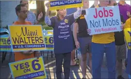  ?? Gina Ferazzi Los Angeles Times ?? SUPPORTERS of the “Yes on Prop. 6” campaign, which seeks to repeal the gas tax, rally outside Rep. Mimi Walters’ headquarte­rs on Saturday in Irvine.