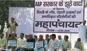  ?? — BUNNY SMITH ?? BJP workers and leaders protest against chief minister Arvind Kejriwal over regularisa­tion of illegal colonies at Rajghat in New Delhi on Monday.