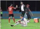  ?? REBECCA BLACKWELL/AP ?? The United States’ Matt Besler sits on the pitch after losing 2-1 against Trinidad and Tobago.