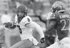  ??  ?? Oklahoma State wide receiver Braydon Johnson (8) runs for a touchdown past Kansas cornerback Duece Mayberry (22) during the first half of a 47-7 win Saturday in Lawrence, Kan. [AP PHOTO/ORLIN WAGNER]