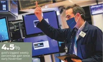  ?? AP ?? A trader on the New York Stock Exchange. On Wall Street, the Dow Jones Industrial Average rose 0.48 per cent and the S&P 500 gained 0.36 per cent, ending the week at new highs.