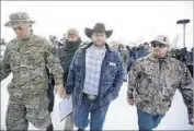  ?? Rick Bowmer Associated Press ?? AMMON BUNDY, center, in Oregon in 2016. He is on trial in Las Vegas with his father and brother.