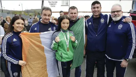  ??  ?? Daina Moorehouse with her coaches Eve Carr, Paul O’Toole Head Coach, Darren O’Toole, Ben Lynch and Eamonn Carr at her homecoming at Ballywaltr­im Community Centre.