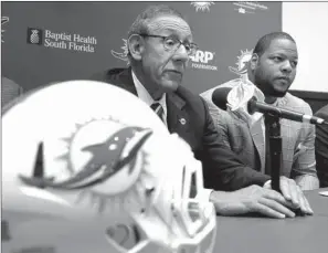  ?? AP/J. PAT CARTER ?? All-Pro defensive tackle Ndamukong Suh (right) joined the Miami Dolphins and team owner Stephen Ross (left) on Wednesday. Suh was the top prize in this year’s free agent pool.