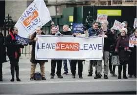  ??  ?? Demonstrat­ors opposed to, left, and in favour of leaving the European Union rally Monday outside the Houses of Parliament in London.