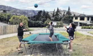  ?? PHOTO: JOHN TAYLOR ?? Fun and exercise . . . In their backyard at Lake Hawea are (from left) Grant, Max (10) and Caitlin (12) Evans.