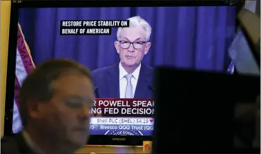  ?? SETH WENIG — THE ASSOCIATED PRESS ?? Federal Reserve Chairman Jerome Powell’s news conference is displayed on television­s while traders work on the floor at the New York Stock Exchange in New York on Wednesday.