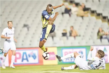 ?? — AFP photo ?? Olympic sprinter Usain Bolt, playing for A-League football club Central Coast Mariners, jumps while controllin­g the ball in his first competitiv­e start for the club against Macarthur South West United in Sydney on October 12, 2018.