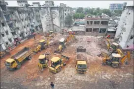  ?? REUTERS ?? Rescue workers remove the rubble during a search operation after the collapse of a building in Gujarat’s Ahmedabad, Monday.