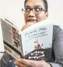 ??  ?? Pablo Lopez Paz reads the descriptio­n of the Divine Dog ‘Passion’ card.