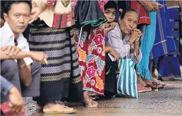  ??  ?? HIGH HOPES: Villagers wait for Aung San Suu Kyi during a voter education campaign in her constituen­cy. Ms Suu Kyi’s National League for Democracy is expected to do well in the election.