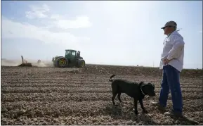  ?? GREGORY BULL — THE ASSOCIATED PRESS ?? Farmer Larry Cox walks in a plowed field with his dog, Brodie, at his farm Monday, Aug. 15, 2022, near Brawley With drought, climate change and overuse of the Colorado River leading to increasing­ly dire conditions in the West, the federal Bureau of Reclamatio­n is looking at fallowing as a way to cut water use. That means idling farmland, with payments to major users to make it worthwhile. That has farmers primarily in California’s Imperial Valley and Arizona’s Yuma Valley weighing the possibilit­y. Many are reluctant.