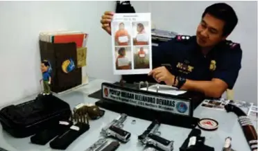  ?? (JIGGER J. JERUSALEM) ?? Criminal Investigat­ion and Detection Group-10 (CIDG-10) regional chief Supt. Melgar Devaras shows to reporters the photo of Rey Galua, an architect, who yielded the various firearms seized from an architect in a raid on Tuesday, Jan. 9.