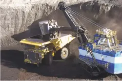  ?? ASSOCIATED PRESS FILE PHOTO ?? A mechanized shovel loads coal last year from an 80-foot-thick seam into a haul truck at Cloud Peak Energy’s Spring Creek mine near Decker, Mont. The Interior Department has put on hold changes to how it values coal extracted from public lands after mining companies sued in federal court to challenge the rules.