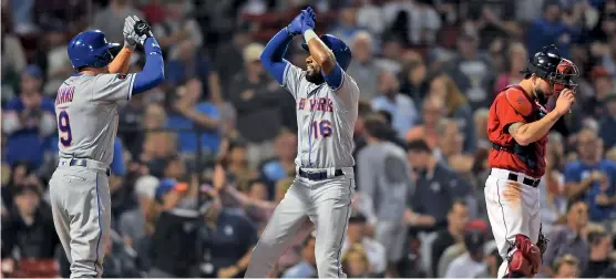  ?? STAFFPHOTO­BYCHRISTOP­HEREVANS ?? TOUGH TO WATCH: The Mets’ Brandon Nimmo (left) and Austin Jackson celebrate behind Red Sox catcher Blake Swihart after Jackson’s home run last night at Fenway. The Sox dropped the opener of the three-game interleagu­e series, 8-0.