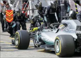  ?? AP PHOTO/POOL PHOTO VIA AP ?? British Formula One driver Lewis Hamilton of Mercedes AMG GP arrives for the pit stop during the 2018 Formula One Grand Prix of Germany at the Hockenheim­ring in Hockenheim, Germany, July 22, 2018.