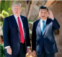  ?? AFP ?? Chinese President Xi Jinping waves to the Press as he walks with US President Donald Trump at the Mar-a-Lago estate in West Palm Beach, Florida. —