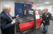  ??  ?? Penn State Great Valley Assistant Professor of Engineerin­g Design Douglas Schumer talks with Leo Daiuto, entreprene­ur in residence at the REV-UP Center for Entreprene­urship at Penn State Great Valley. The demonstrat­ion of a water jet cutting machine is...