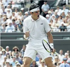  ?? KIRSTY WIGGLESWOR­TH/THE ASSOCIATED PRESS ?? Milos Raonic celebrates after winning the first set against Germany’s JanLennard Struff during their Men’s Singles Match on day two at the Wimbledon Tennis Championsh­ips in London Tuesday. Raonic defeated Struff in straight sets.