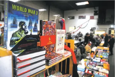  ?? Photos by Paul Chinn / The Chronicle ?? Books are displayed by PM Press publishers at the 20th annual Bay Area Anarchist Book Fair in Oakland.