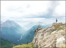  ??  ?? In this Aug 14, 2015 photos, Associated Press writer Erin Gartner takes in theview along the Highline Trail in Glacier National Park in Montana. (AP)