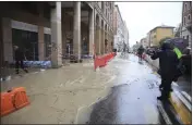  ?? MICHELE NUCCI — LAPRESSE VIA AP ?? Sandbags are lined up along a flooded street in downtown Bologna, Italy, on Tuesday.