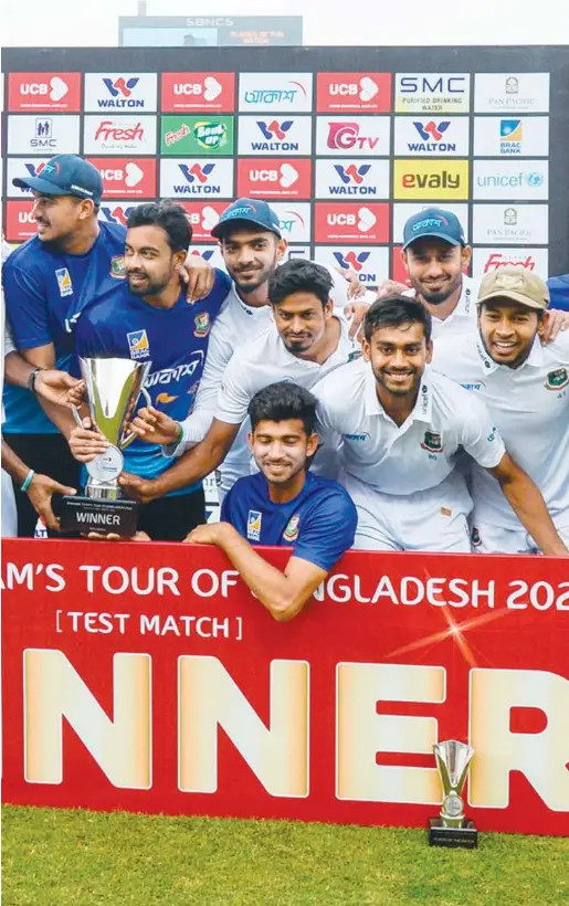  ??  ?? Bangladesh’s players pose with the trophy after winning the Test against Zimbabwe in Dhaka on Tuesday. Agence France-presse