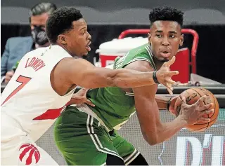  ?? CHRIS O’MEARA THE ASSOCIATED PRESS ?? Raptors guard Kyle Lowry defends his ground against Boston’s Aaron Nesmith during action Monday night. The Raptors lost 126-114 to fall to 1-5 this season.