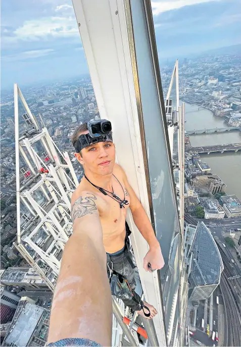  ?? ?? Adam Lockwood at the top of the Shard after climbing London’s 72-storey glass skyscraper yesterday morning. He was previously banned from all constructi­on sites in England