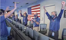  ?? TOP: AP;
LEFT: BILL INGALLS/ NASA VIA AP ?? The surface of Mars is seen above. NASA’s Perseveran­ce rover team, left, reacts in mission control Thursday at NASA’s Jet Propulsion Laboratory in Pasadena, Calif., after receiving confirmati­on the spacecraft touched down on Mars.