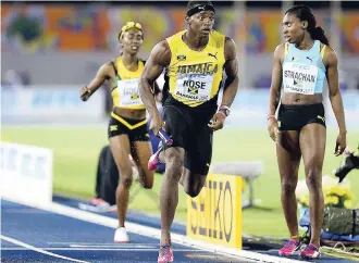  ?? FILE ?? Jamari Rose collects the baton from Natoya Goule in the mixed 4x400m relay finals at the 2017 World Relays in Nassau, Bahamas. The nation has since decided not to continue hosing the championsh­ips because of the high cost associated with it. Since then, Jamaica had unsuccessf­ully attempted to gain hosting right for next year’s event.