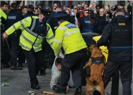 ??  ?? Mayhem: Gardaí and protesters on Grafton Street on Saturday