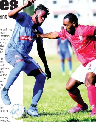  ?? FILE ?? Action from the Red Stripe Premier League as Dunbeholde­n’s Deandre Thomas (left) takes on UWI FC’s Fabion McCarthy in a match at the UWI Mona Bowl on Sunday, January 12.