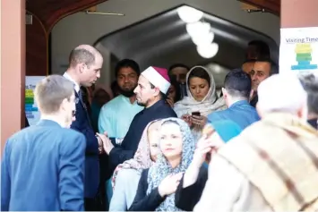  ?? — AFP photo ?? Imam Gamal Fouda (centre) of Al Noor mosque bids farewell to Prince William after his visit in Christchur­ch.